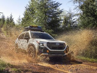 2026 subaru forester wilderness edition offroad wagon splashing through mud.